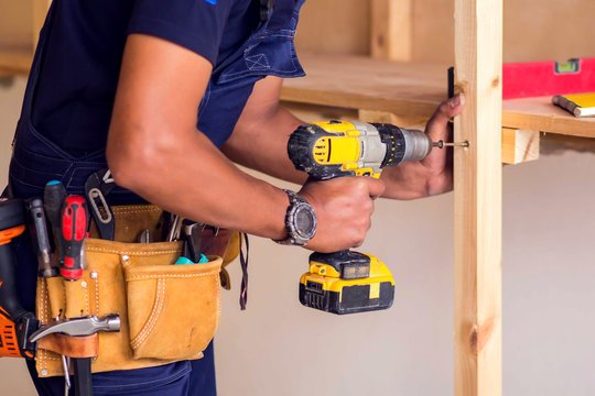 Handyman Using Power Drill for Home Repairs